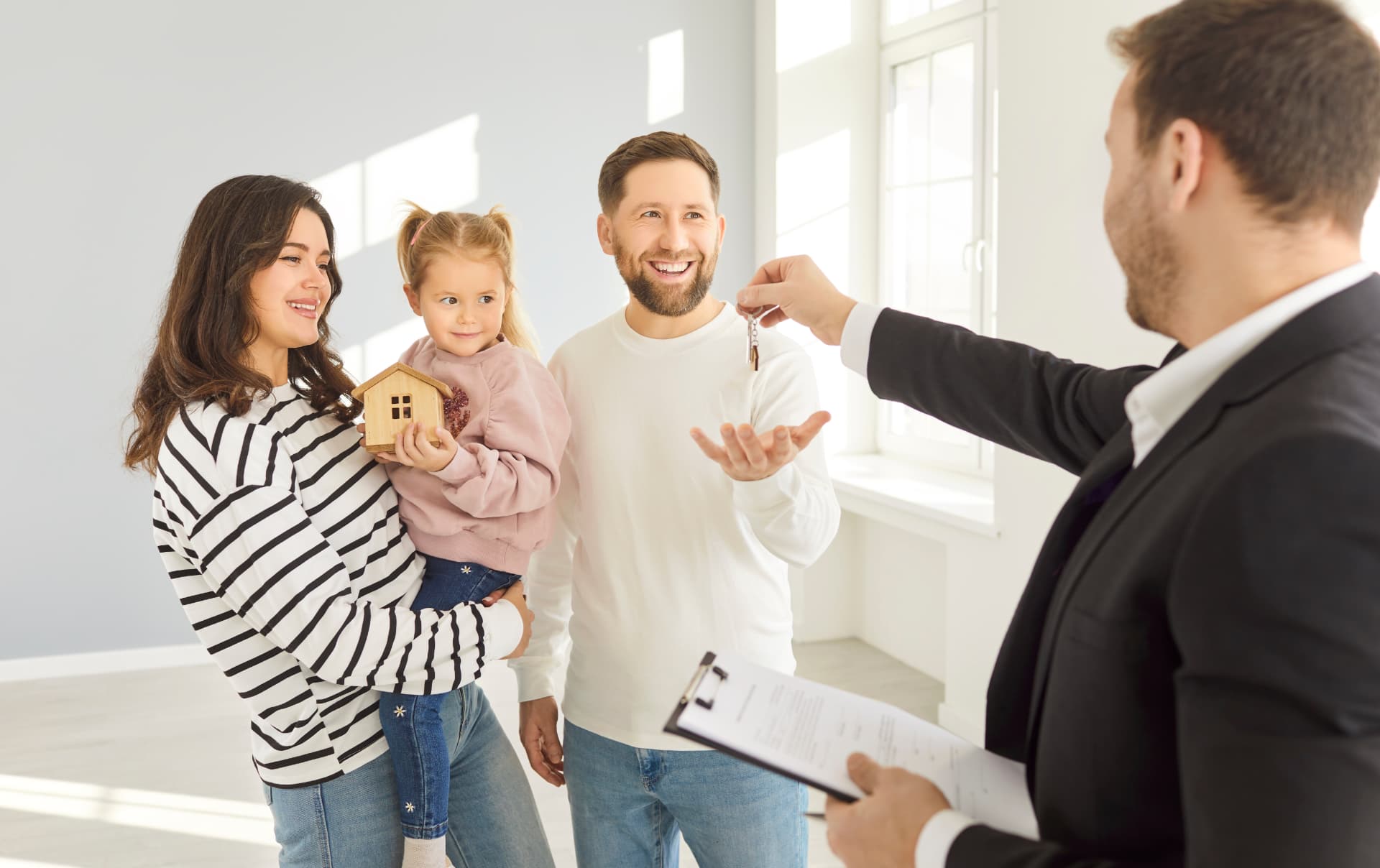 Happy family receiving keys to their new home